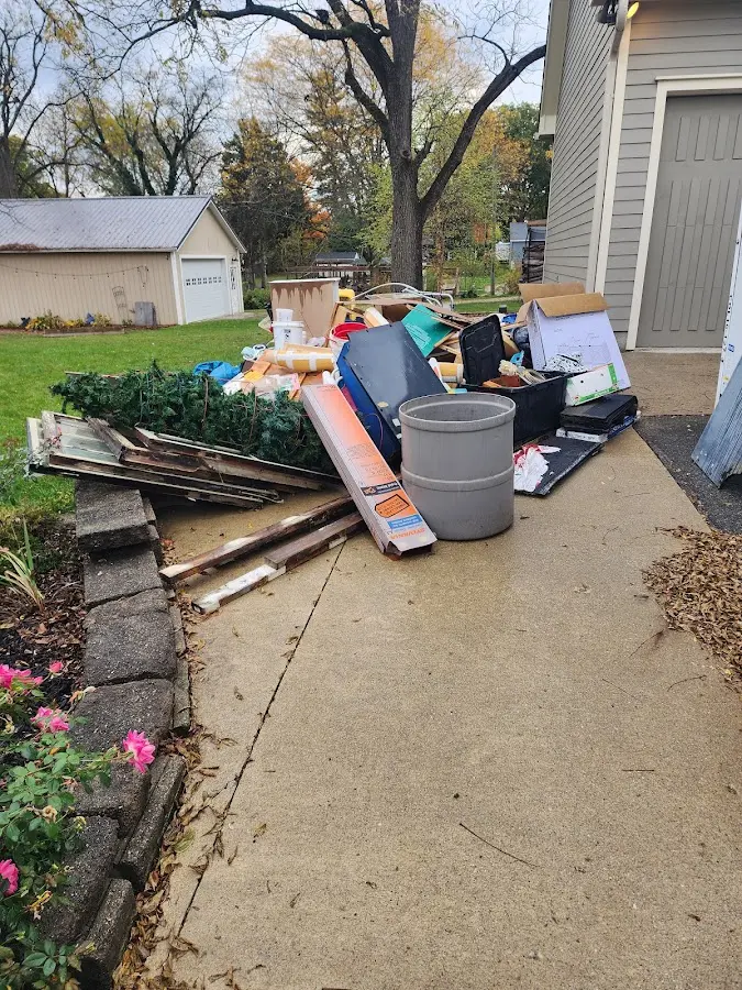 Dumpster being loaded with debris for 12 Yard Dumpster Rental in Somers Point